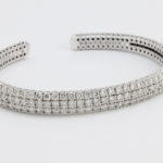 Flexible design cuff  - Prong set round diamonds