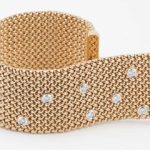 18 karat yellow gold flat mesh bracelet with 17 round diamonds bezel set in 18 karat white gold